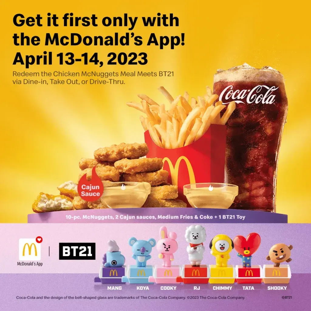 Promotional graphic for a McDonald’s app meal deal reading “Get it first only with the McDonald’s App! April 13-14, 2023,” featuring Coca-Cola cups, fries, and a row of BT21 collectible characters.