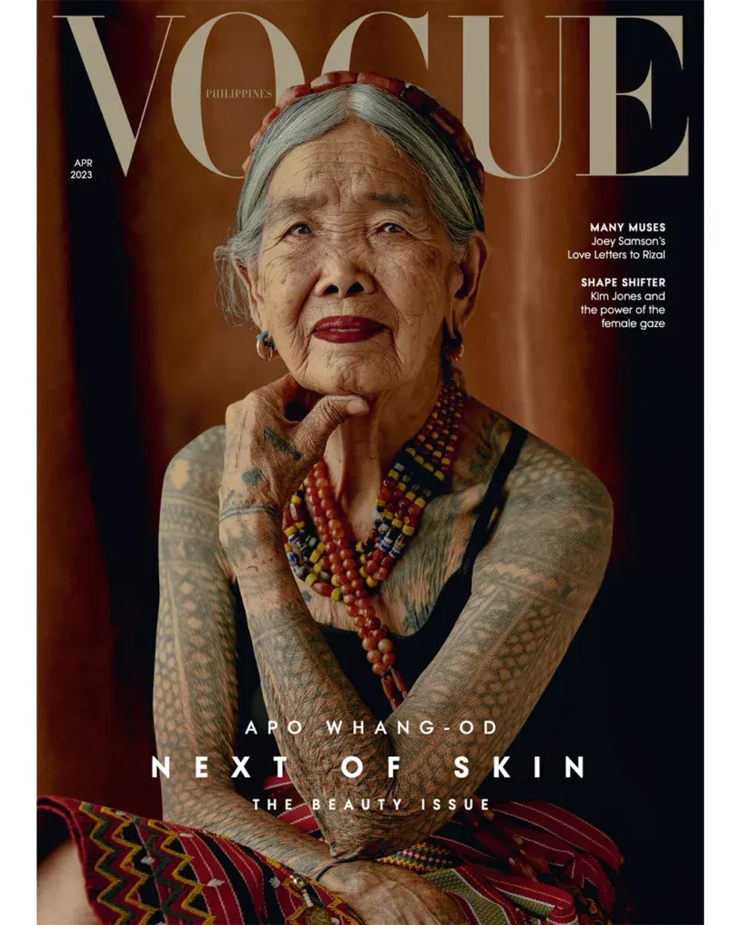 Magazine cover with the masthead “VOGUE” above an elderly person with traditional tattoos, with cover lines including “NEXT OF SKIN” and “THE BEAUTY ISSUE.”